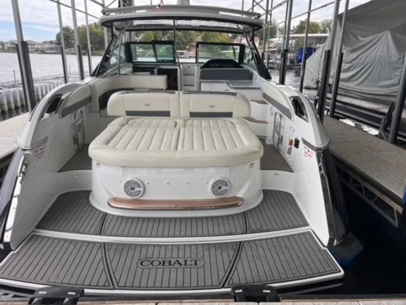 Slide: The Image of 2019 Cobalt A40 boat with spacious seating and elegant design in a marina setting. - 2