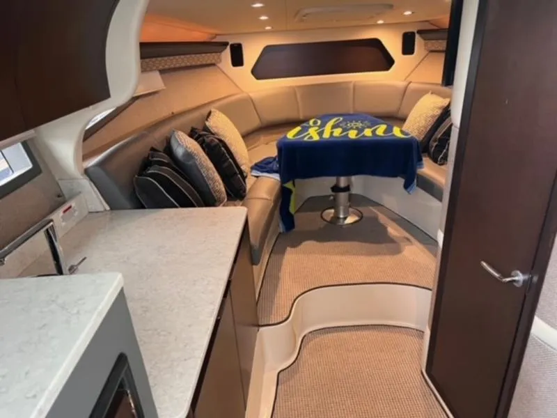 Slide: The Image of 2019 Cobalt A40 boat interior with cozy seating and table setup. - 4