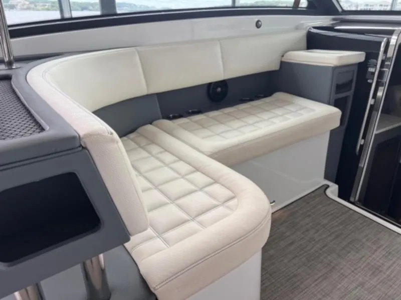 Slide: The Image of 2019 Cobalt A40 boat interior with white cushioned seating and modern design. - 5