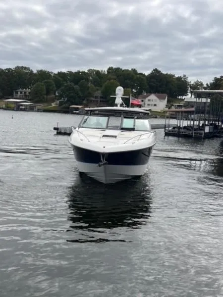 Slide: The Image of 2019 Cobalt A40 boat on a lake with cloudy skies and shoreline houses. - 7