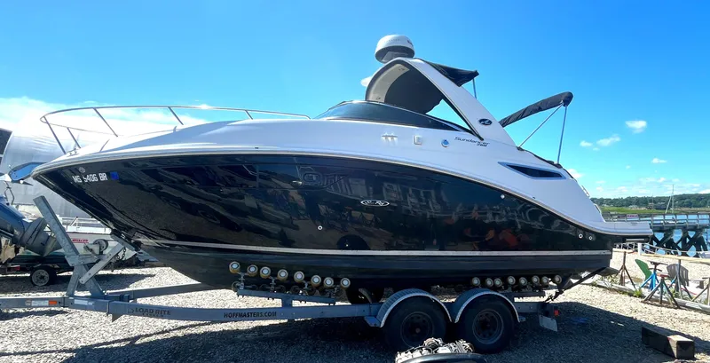 The Image of 2014 Sea Ray 260 Sundancer boat on trailer under clear blue sky. - 0