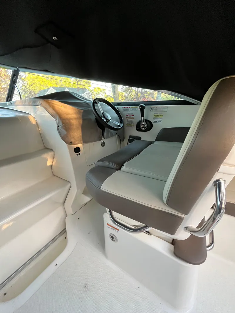 Slide: The Image of 2014 Sea Ray 260 Sundancer helm with steering wheel and seating. - 11