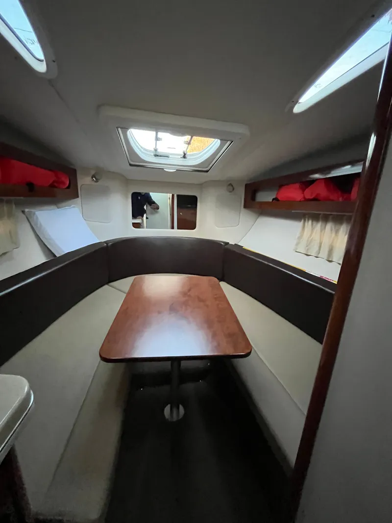 Slide: The Image of 2014 Sea Ray 260 Sundancer cabin interior with table and seating. - 12