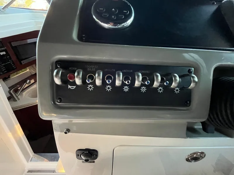 Slide: The Image of Control panel of a 2014 Sea Ray 260 Sundancer boat with switches and dials. - 17
