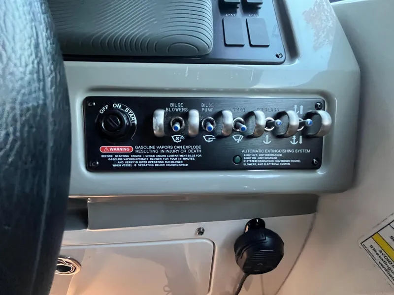 Slide: The Image of Control panel of a 2014 Sea Ray 260 Sundancer boat with various switches. - 18