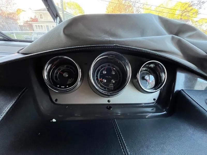 Slide: The Image of Dashboard of a 2014 Sea Ray 260 Sundancer boat with three gauges. - 20
