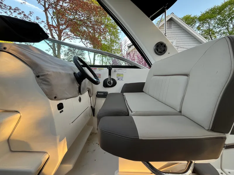 Slide: The Image of 2014 Sea Ray 260 Sundancer interior with helm and seating, showcasing modern design and comfort. - 22