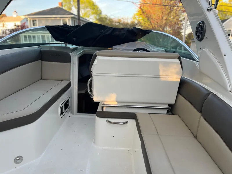 Slide: The Image of 2014 Sea Ray 260 Sundancer boat interior with cushioned seating and modern design. - 25