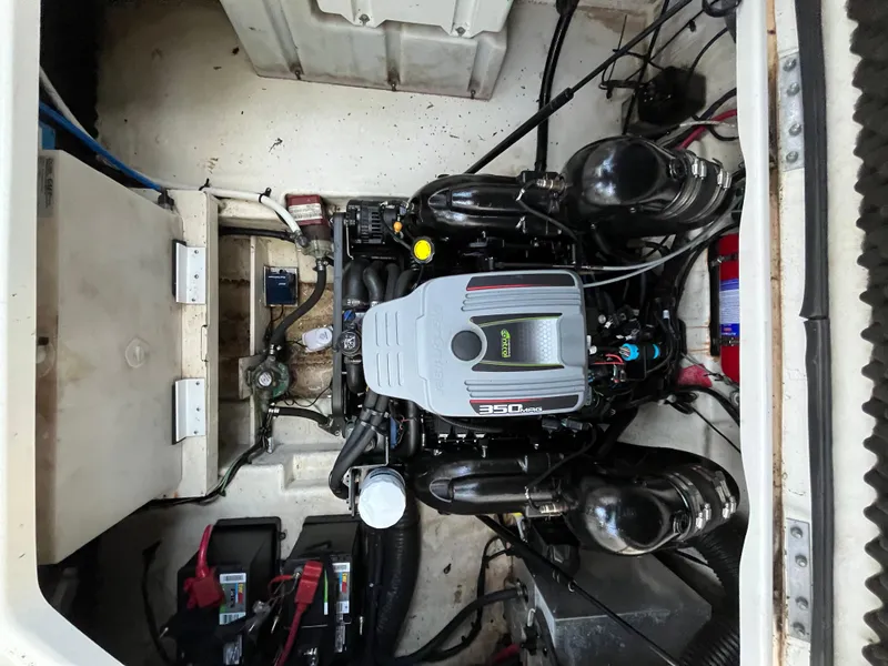 Slide: The Image of Engine compartment of a 2014 Sea Ray 260 Sundancer boat, showcasing the engine and components. - 26