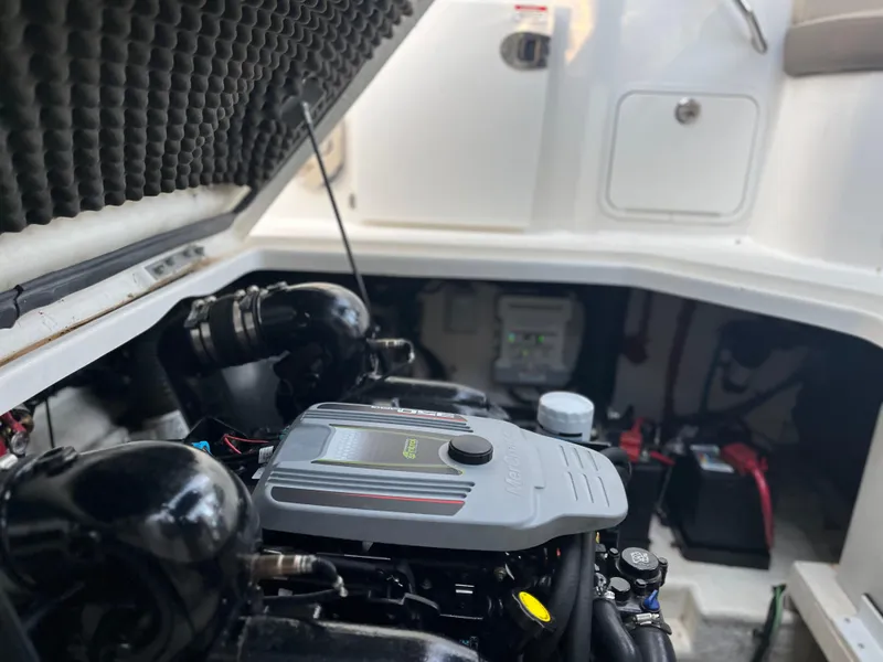 Slide: The Image of Engine compartment of a 2014 Sea Ray 260 Sundancer boat, showcasing mechanical components. - 28