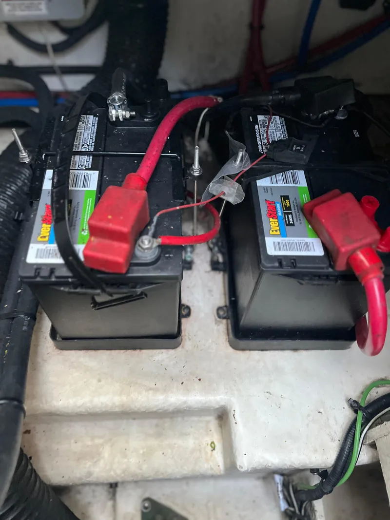 Slide: The Image of Batteries in a 2014 Sea Ray 260 Sundancer boat, connected with red cables. - 29
