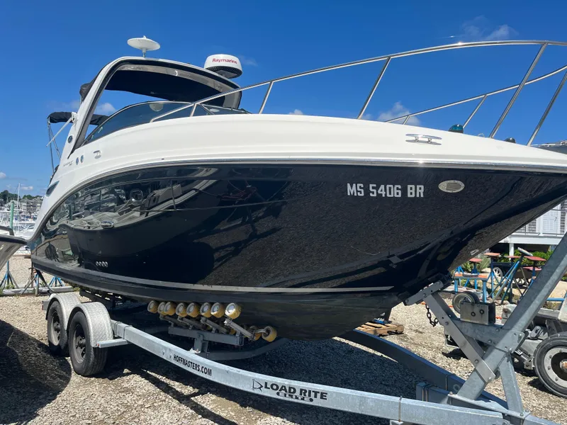 Slide: The Image of 2014 Sea Ray 260 Sundancer boat on trailer, displayed outdoors under clear blue sky. - 3