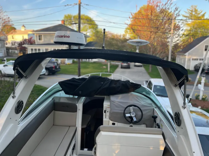 Slide: The Image of 2014 Sea Ray 260 Sundancer boat with Raymarine equipment, docked in a residential area. - 31