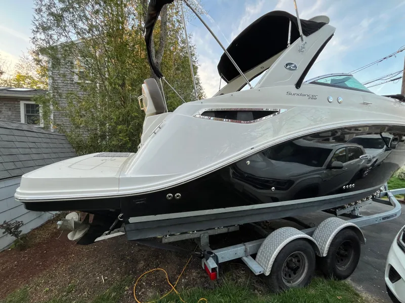 Slide: The Image of 2014 Sea Ray 260 Sundancer boat on trailer, parked outdoors. - 35