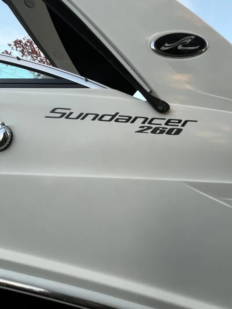 Slide: The Image of 2014 Sea Ray 260 Sundancer boat exterior with logo and branding details. - 39