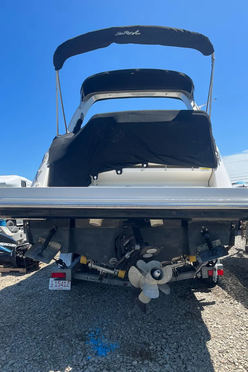 Slide: The Image of 2014 Sea Ray 260 Sundancer boat, rear view, on trailer under clear blue sky. - 6