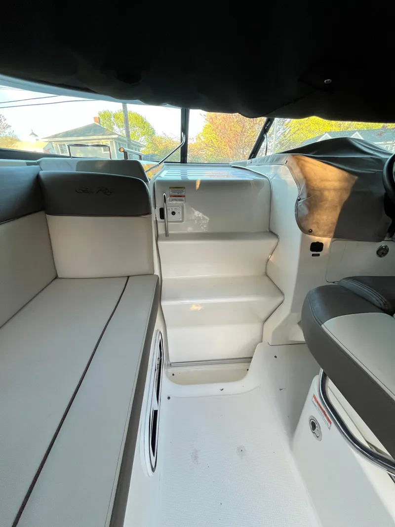 Slide: The Image of 2014 Sea Ray 260 Sundancer interior with seating and helm, showcasing modern design. - 7