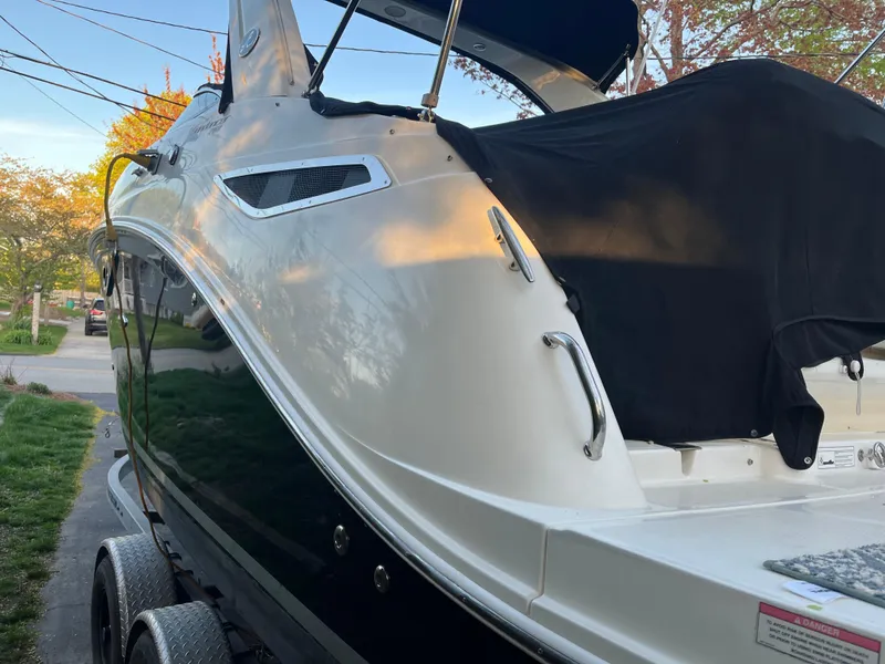 Slide: The Image of 2014 Sea Ray 260 Sundancer boat on trailer, parked outdoors. - 8