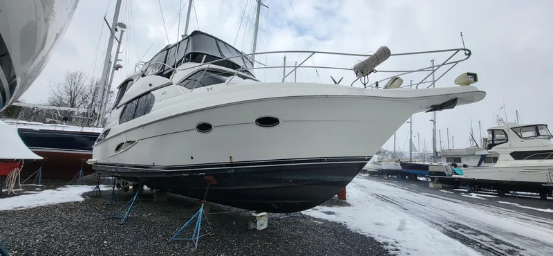 Slide: The Image of 2007 Silverton 43 Motor Yacht on stands in snowy marina setting. - 0