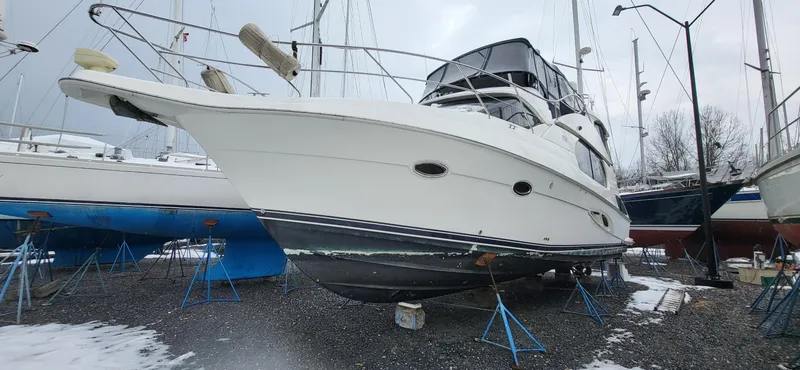 Slide: The Image of 2007 Silverton 43 Motor Yacht on stands in a snowy boatyard. - 1