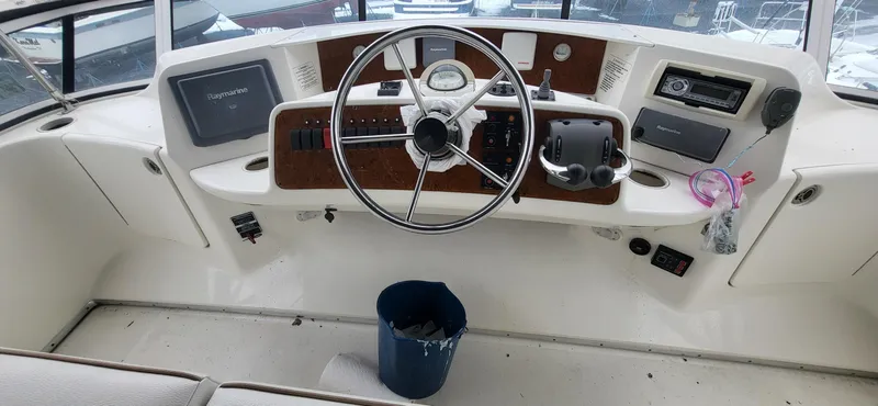 Slide: The Image of 2007 Silverton 43 Motor Yacht helm with steering wheel and navigation equipment. - 10