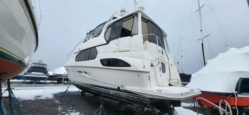 Slide: The Image of 2007 Silverton 43 Motor Yacht on stands in snowy marina. - 13