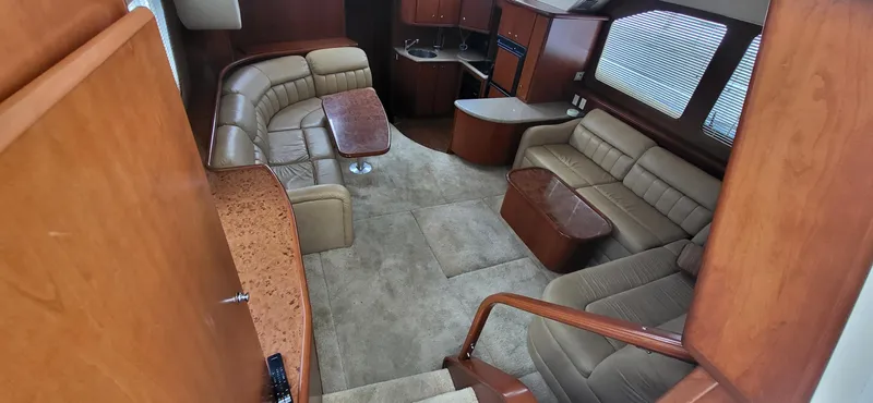 Slide: The Image of Interior of 2007 Silverton 43 Motor Yacht with plush seating and wooden accents. - 15