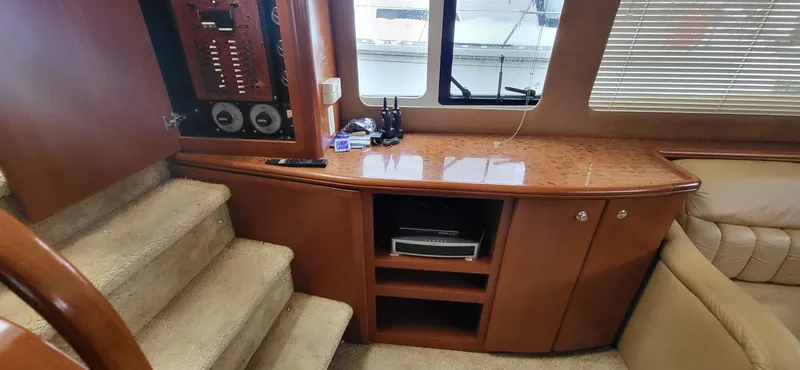 Slide: The Image of Interior of 2007 Silverton 43 Motor Yacht with wooden cabinetry and carpeted stairs. - 16