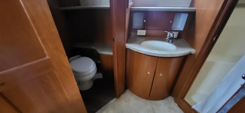 Slide: The Image of 2007 Silverton 43 Motor Yacht bathroom with wooden cabinetry and compact sink. - 17
