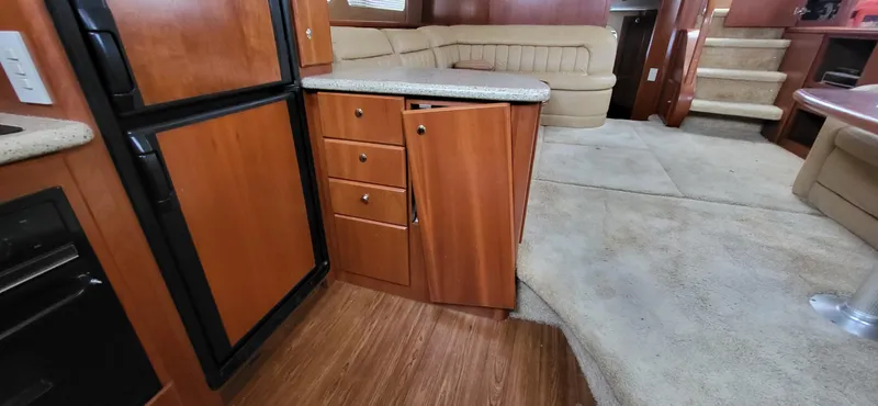 Slide: The Image of Interior of 2007 Silverton 43 Motor Yacht with wood cabinetry and beige seating. - 19