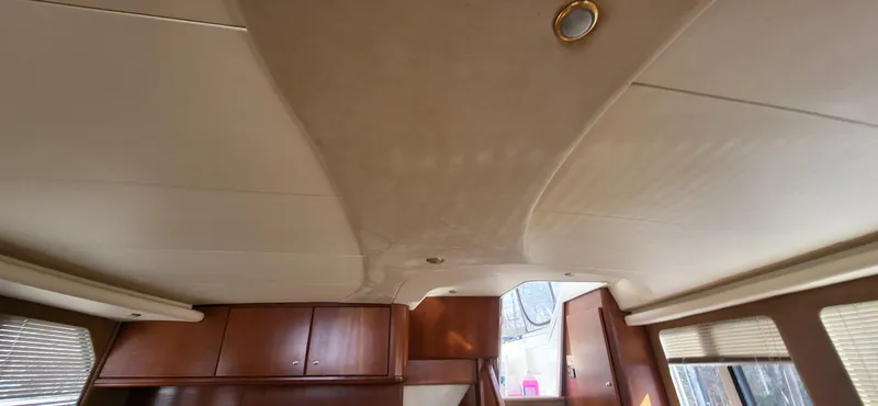 Slide: The Image of 2007 Silverton 43 Motor Yacht interior ceiling with wood cabinets and natural light. - 6