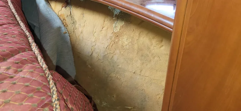 Slide: The Image of 2007 Silverton 43 Motor Yacht interior showing wall damage and wear. - 7