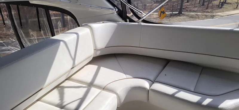 Slide: The Image of 2007 Silverton 43 Motor Yacht interior seating area with white upholstery. - 9