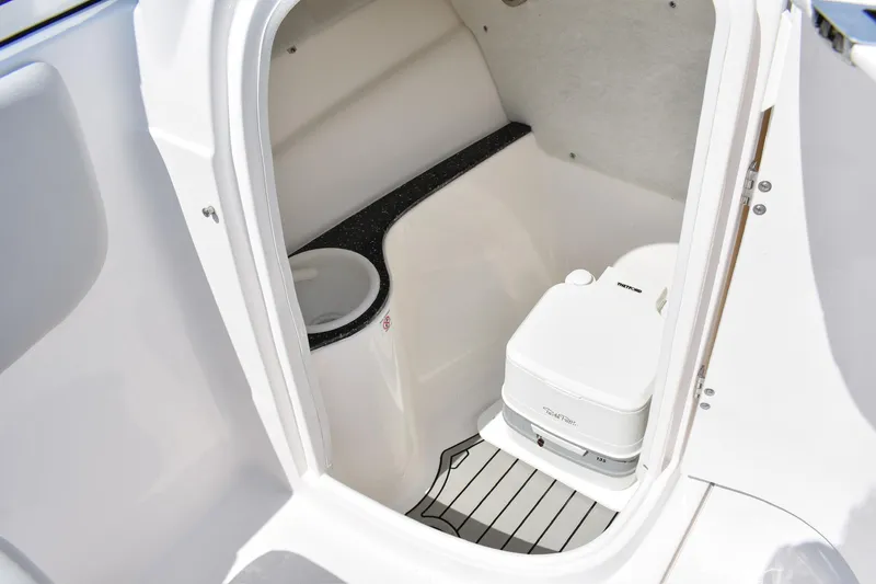 Slide: The Image of 2020 Sea Fox 226 Traveler boat interior with compact marine toilet and storage space. - 10