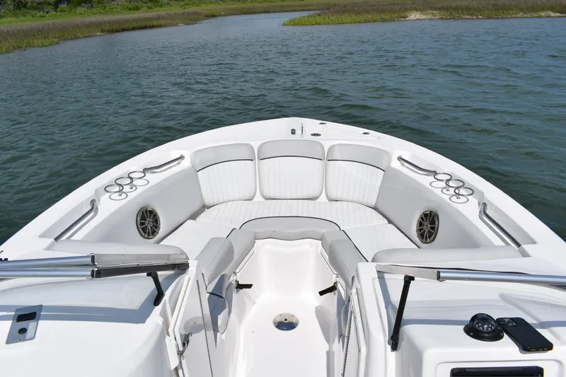 Slide: The Image of 2020 Sea Fox 226 Traveler boat interior with cushioned seating and cup holders on calm water. - 4