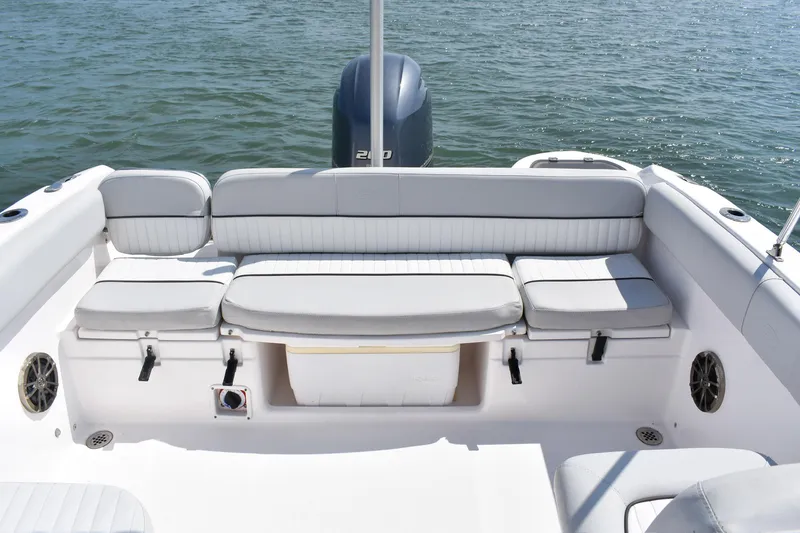 Slide: The Image of 2020 Sea Fox 226 Traveler boat interior with cushioned seating and ocean backdrop. - 5