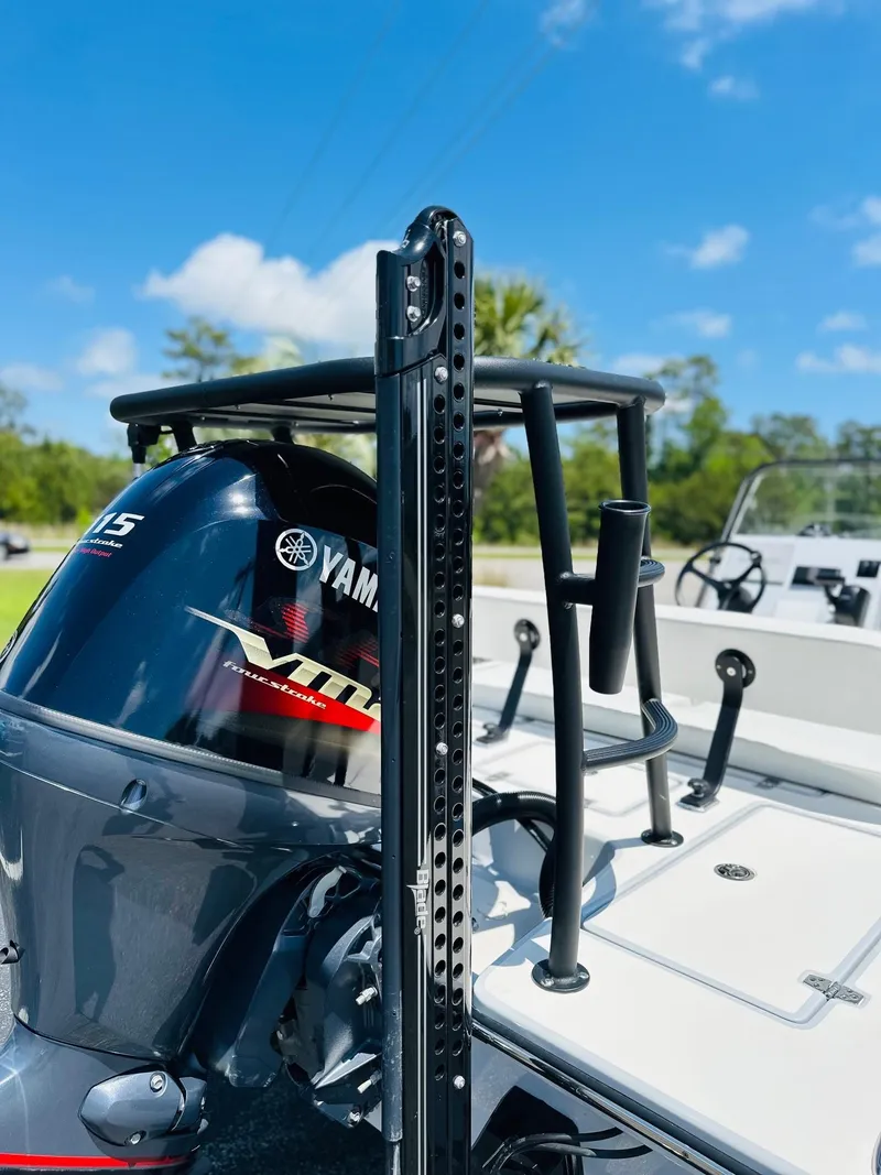 Slide: The Image of 2022 Hewes Redfisher 18 boat with Yamaha VMAX engine, under clear blue sky. - 14