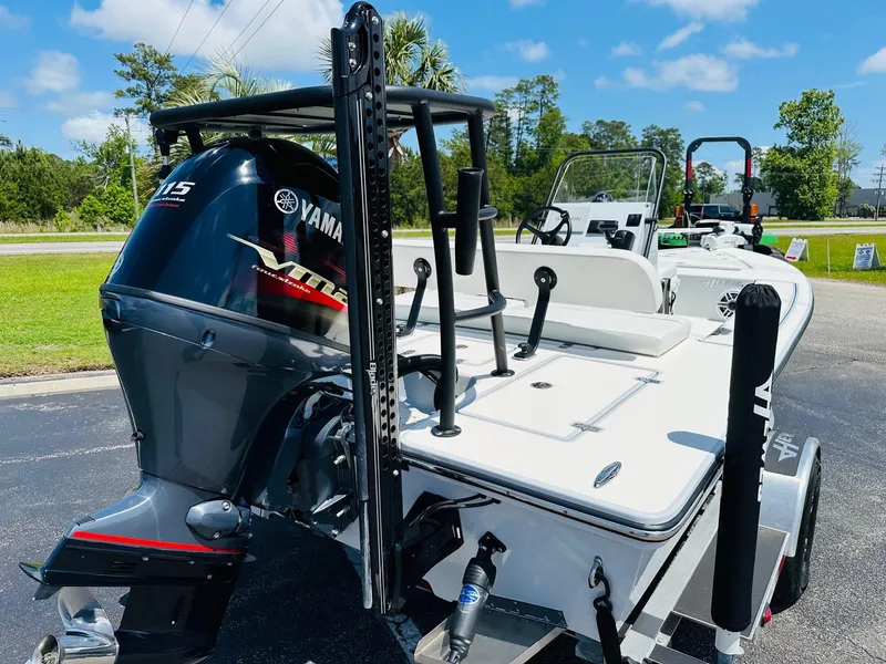 Slide: The Image of 2022 Hewes Redfisher 18 boat with Yamaha engine, parked outdoors on a sunny day. - 15