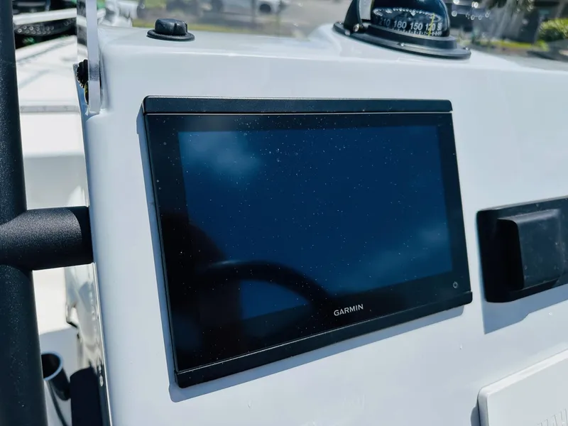 Slide: The Image of 2022 Hewes Redfisher 18 boat dashboard with Garmin display and compass. - 3