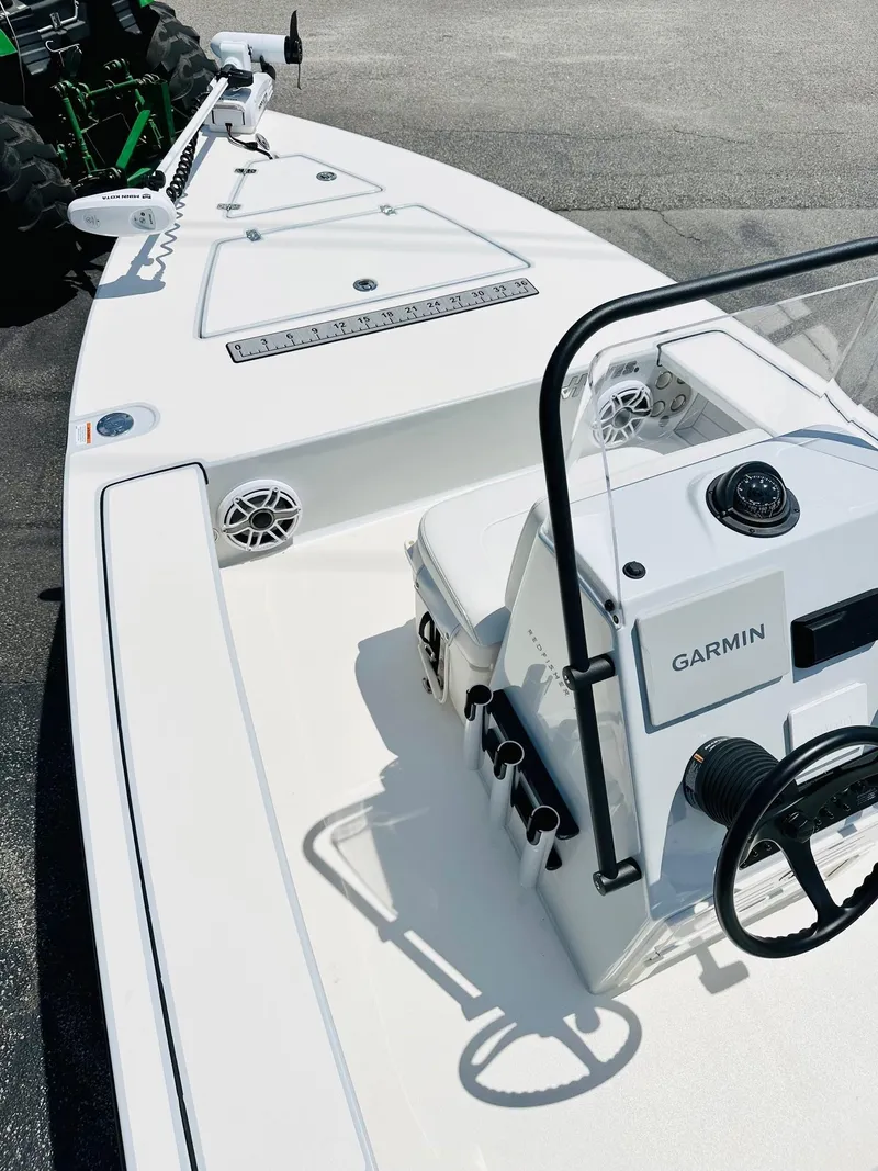 Slide: The Image of 2022 Hewes Redfisher 18 boat with Garmin equipment, featuring a sleek white deck design. - 8