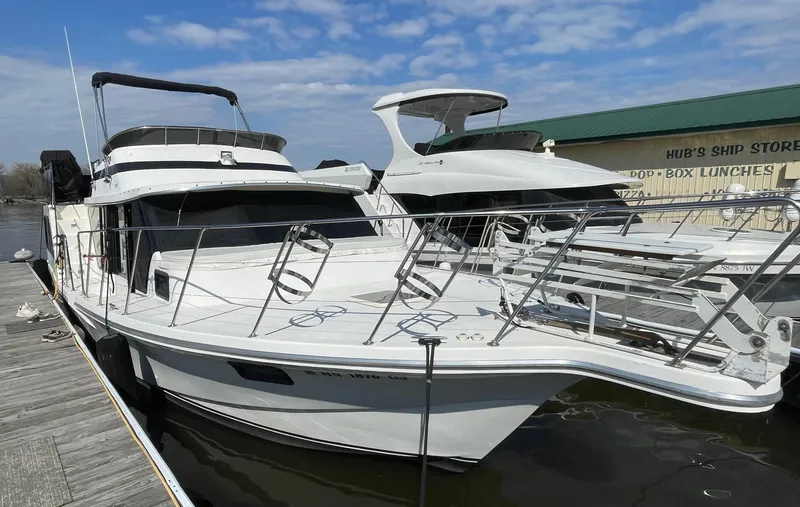 Slide: The Image of 1984 Bluewater 42 Coastal Cruiser docked, featuring sleek design and spacious deck. - 1