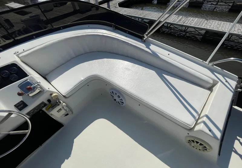 Slide: The Image of 1984 Bluewater 42 Coastal Cruiser boat with white seating and control panel. - 14