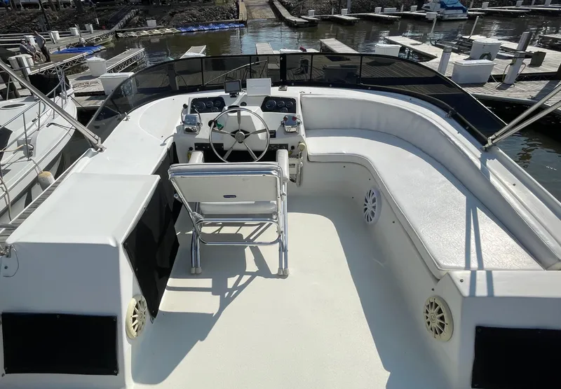 Slide: The Image of 1984 Bluewater 42 Coastal Cruiser helm with seating, docked at marina. - 17