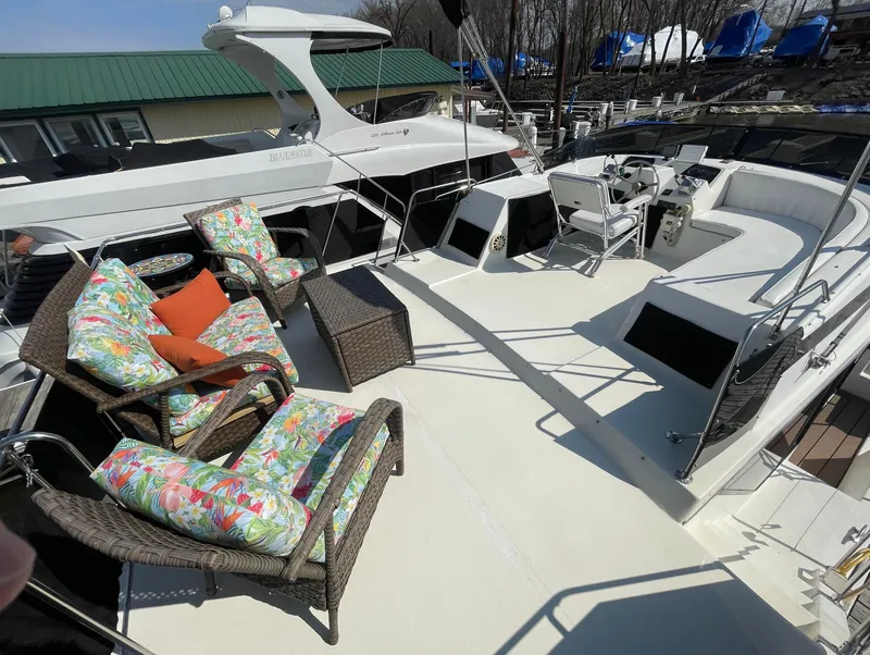 Slide: The Image of 1984 Bluewater 42 Coastal Cruiser with outdoor seating and helm, docked at marina. - 18