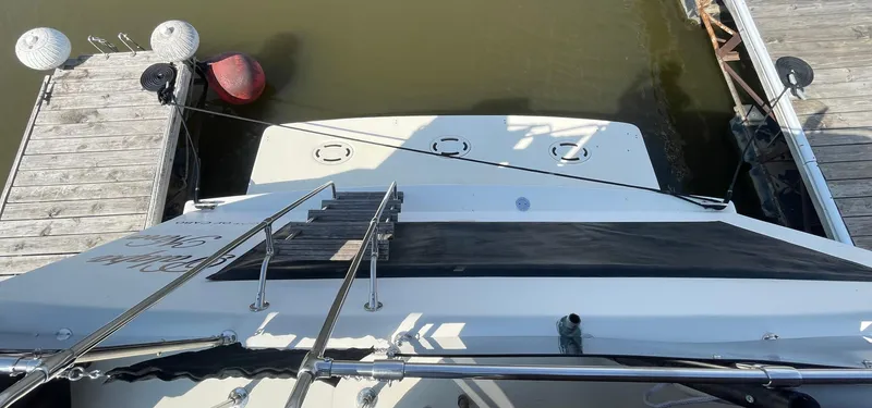 Slide: The Image of 1984 Bluewater 42 Coastal Cruiser docked, viewed from above, showing deck and water. - 19