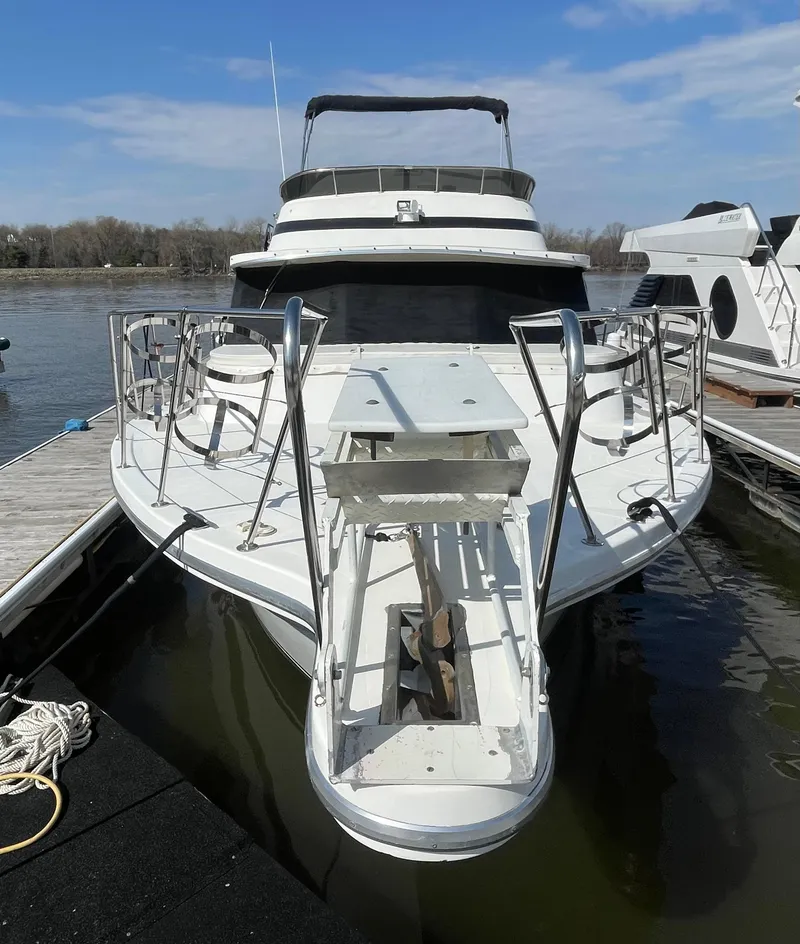 Slide: The Image of 1984 Bluewater 42 Coastal Cruiser docked, showcasing sleek design and spacious deck. - 2