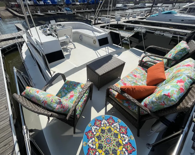 Slide: The Image of 1984 Bluewater 42 Coastal Cruiser with colorful deck seating and vibrant table design. - 20