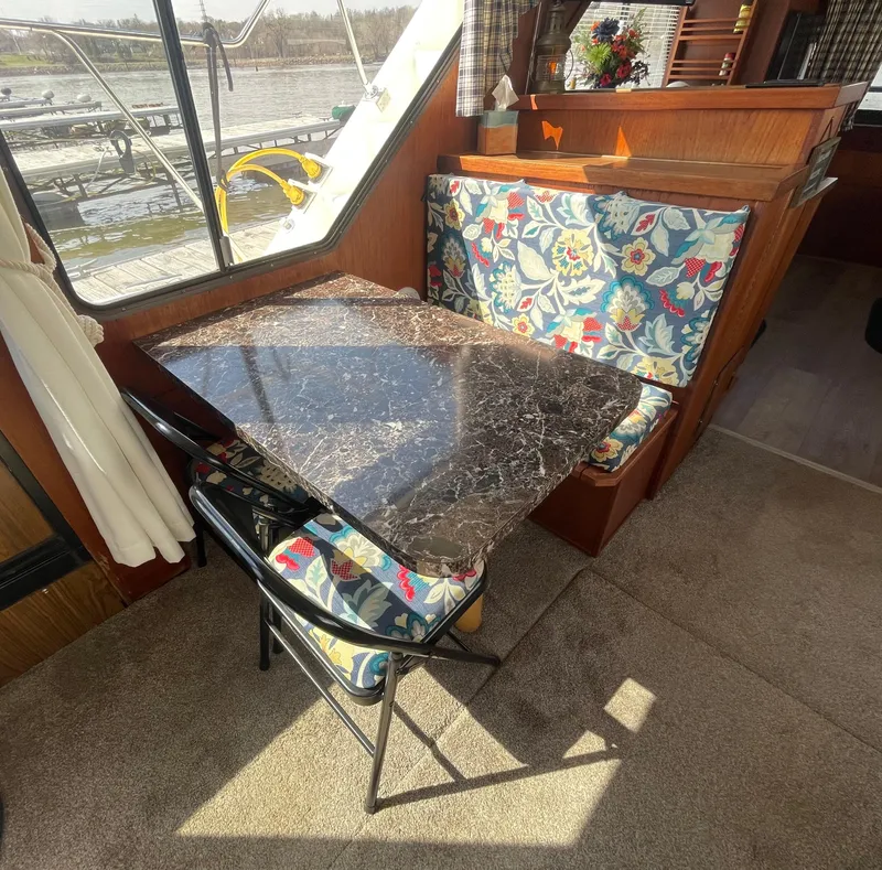 Slide: The Image of 1984 Bluewater 42 Coastal Cruiser interior with floral seating and marble table. - 22