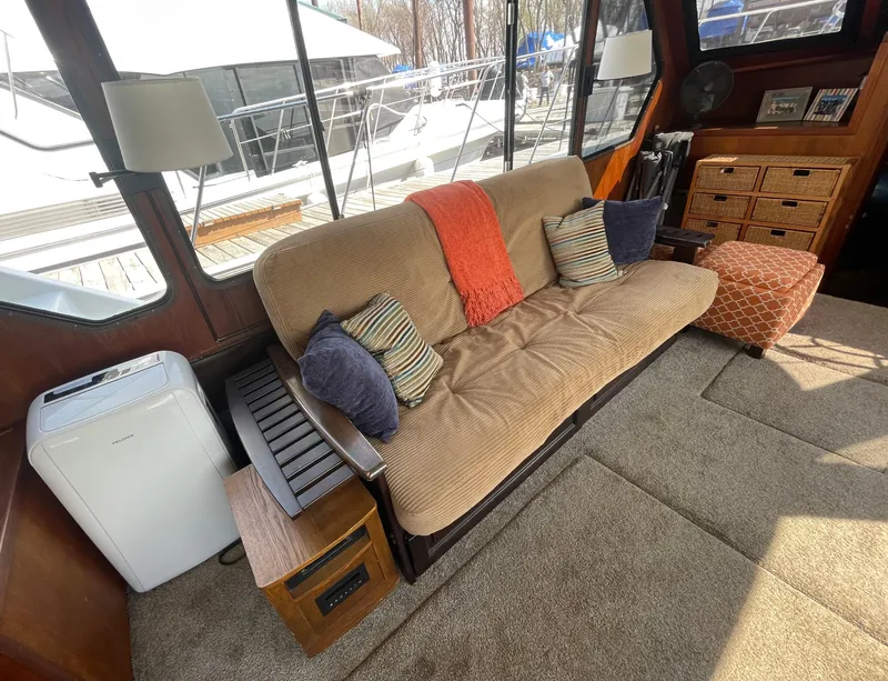 Slide: The Image of Interior of 1984 Bluewater 42 Coastal Cruiser with cozy seating and nautical decor. - 23