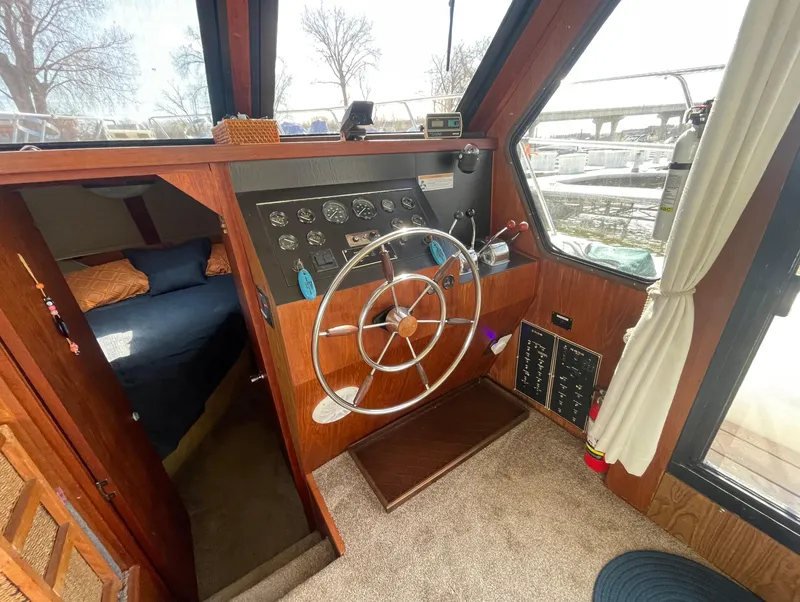 Slide: The Image of 1984 Bluewater 42 Coastal Cruiser helm with wooden interior and steering wheel. - 27
